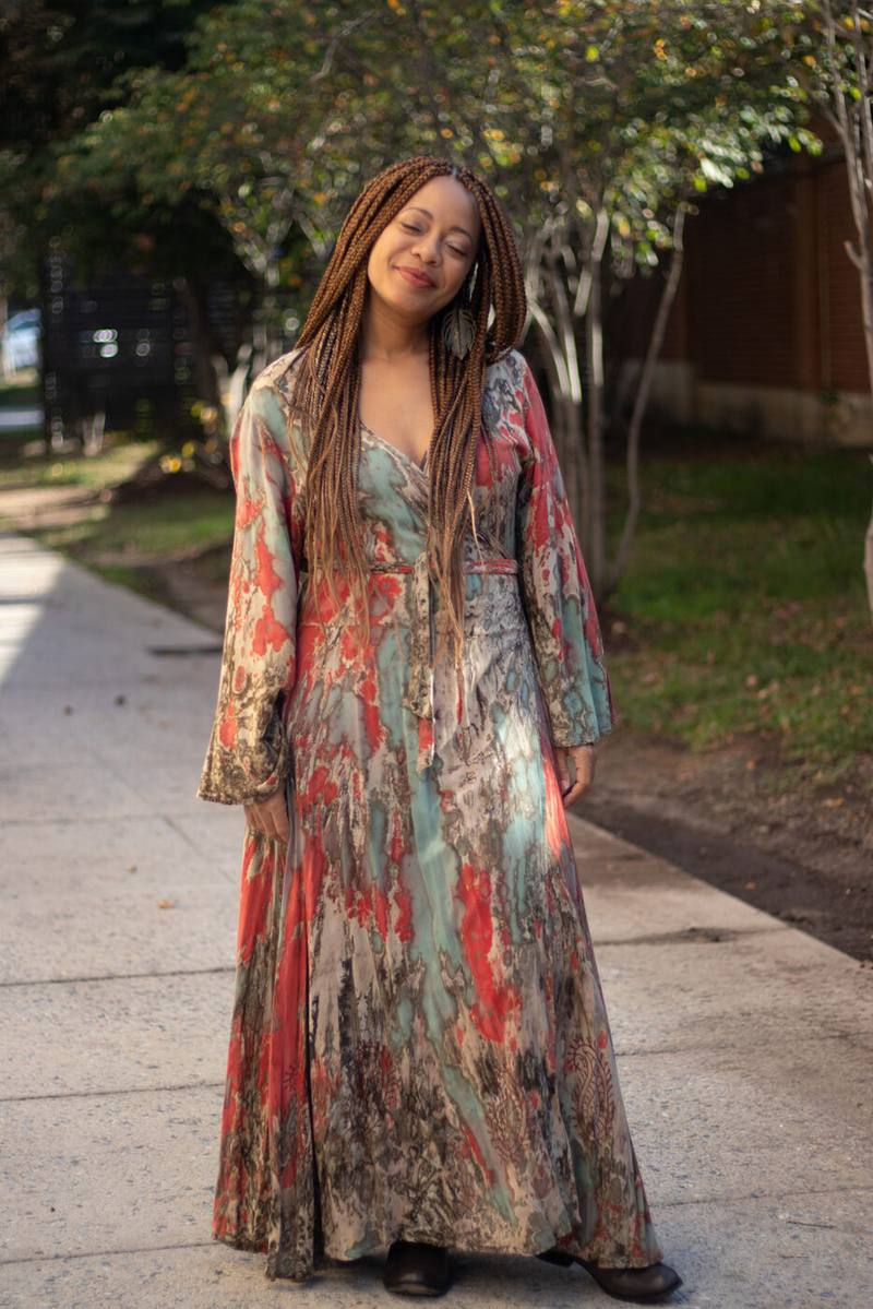 Leslie Holley outdoors in a flowing print dress